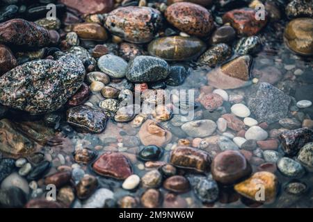 Smooth sea stones. Sea shore. Background Stock Photo