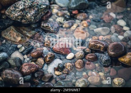 Smooth sea stones. Sea shore. Background Stock Photo