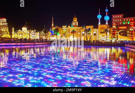 DUBAI, UAE - MARCH 6, 2020: Watch the light show on underwater LED screen in pond of Global Village Dubai, lined with pavilions of different countries Stock Photo