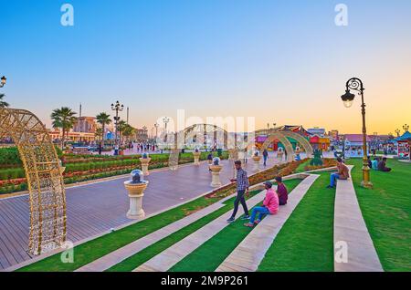 DUBAI, UAE - MARCH 6, 2020: Illuminated arches on pedestrian alley in green park of Global Village Dubai, on March 6 in Dubai Stock Photo