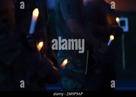 The candles held by members from the 633d Security Forces Squadron at the candlelight vigil during National Police Week at Joint Base Langley-Eustis, Virginia, May 20, 2022. The vigil was held in memoriam of fallen Defenders from years past during JBLE’s National Police Week events. Stock Photo