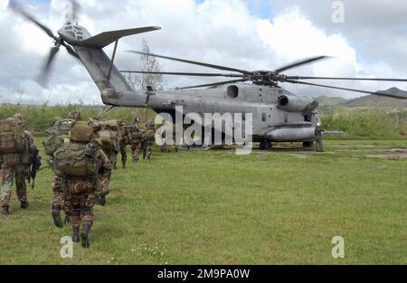 US Army (USA) Soldiers from the 2nd Battalion, 27th Infantry Regiment (2/27) Charlie Company, 25th Infantry Division (ID) [Light], Schofield Barracks, Hawaii (HI), board a US Marine Corps (USMC) CH-53 Sea Stallion helicopter, Marine Medium Helicopter Squadron-263 (HMM-263) at Polaris Point Guam Naval Station for transport to Tinian Island. This is part of an Airborne Insert onto an island during Exercise TANDEM THRUST 2003. Base: Polaris Point Guam Naval Station State: Guam (GU) Country: Northern Mariana Islands (MNP) Stock Photo