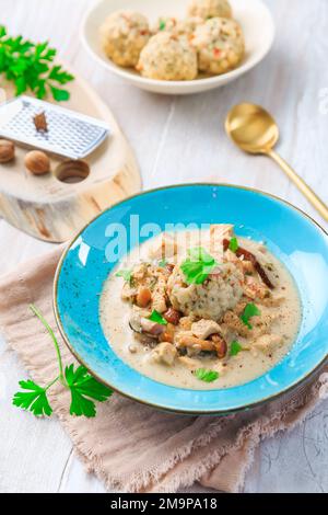 Homemade Bavarian bread dumpling, called in south Germany as Semmelknoedel with creamed mushroom sauce Stock Photo