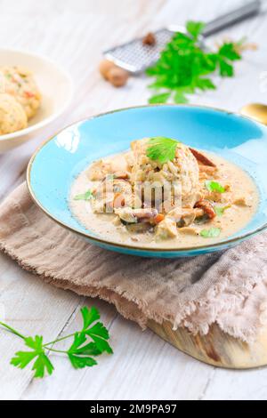 Homemade Bavarian bread dumpling, called in south Germany as Semmelknoedel with creamed mushroom sauce Stock Photo