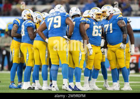 Los Angeles Chargers players huddle during an NFL football game