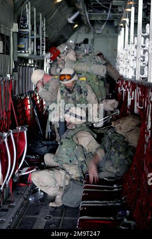 US Marine Corps (USMC) Marines assigned to Lima/Company, 3rd Battalion, 23rd Marine Regiment, gather weapons and gear before exiting a KC-130 Hercules aircraft assigned to Marine Aerial Refueler Transport Squadron Two Three Four (VMGR-234), after arriving at Blair Field in Al Kut, Iraq, during Operation IRAQI FREEDOM. Subject Operation/Series: IRAQI FREEDOM Base: Blaire Airfield, Al Kut State: Wasit Country: Iraq (IRQ) Stock Photo