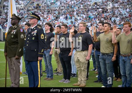 U.S. Air Force recruits are sworn in during halftime on Salute to Service  military appreciation day at an NFL football game between the Jacksonville  Jaguars and the Las Vegas Raiders, Sunday, Nov.