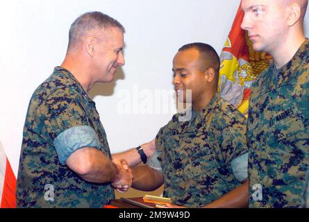 031030-M-5590R-002. US Marine Corps (USMC) Colonel (COL) Michael K. Hicks (left), Chief of Staff, Marine Corps Combat Development Center (MCCDC), Marine Corps Base (MCB) Quantico, Virginia (VA), presents awards to NCO (Non Commissioned Officer) of the Quarter, USMC Sergeant (SGT) Tommy R. Eggleston (middle) and (USMC) Marine of the Quarter, USMC Lance Corporal (LCPL) Michael P. Gudgeon. Stock Photo