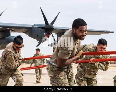 U.S. Airmen assigned to the 27th Special Operations Maintenance Group compete in a C-130 pull during Aviation Maintenance Technician day at Cannon Air Force Base, N.M., May 20, 2022. AMT day is an annual celebration that highlights the accomplishments of aviation maintenance professionals, as well as Charles Edward Taylor, who built the engine for the Wright Brothers. Stock Photo