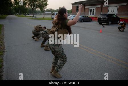 Communication Strategy and Operations Marines with 2d Marine Division and 2d Marine Logistics execute burpees during a workout of the day on Camp Lejeune, North Carolina, May 20, 2022. This workout is in remembrance of Lance Cpl. Jacob A. Hug and Cpl. Sara A. Medina deployed to Kathmandu, Nepal with Joint Task Force 505 shortly after a 7.8 magnitude earthquake struck the country on April 25, 2015. The task force was called upon by the Nepalese Government to provide humanitarian relief shortly after the earthquake. On May 12, another 7.4 magnitude earthquake struck the country and JTF 505 conti Stock Photo