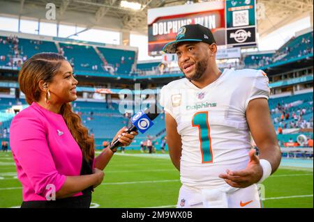 CBS Sports sideline reporter AJ Ross interviews Miami Dolphins quarterback  Tua Tagovailoa (1) on the field