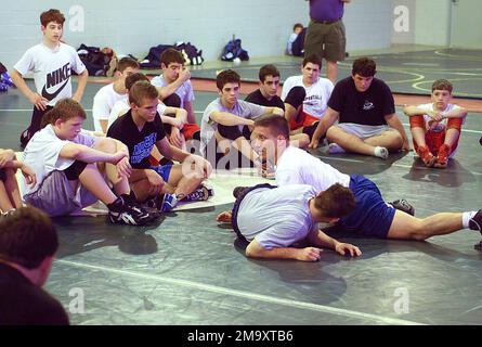040306-M-0267C-607. US Marine Corps (USMC) Major (MAJ) Jay Antonelli, Coach of the All Marines Wrestling Team, takes time out to work with a group of young wrestlers at the Olympic Training Facility during the Armed Forces Wrestling Championship held in New Orleans, Louisiana (LA). Stock Photo