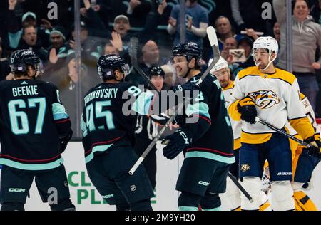 Seattle Kraken forward Andre Burakovsky, left, battles Tampa Bay