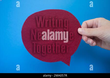 Speech bubble in front of colored background with Writing New Code Together text. Stock Photo