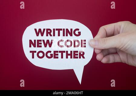 Speech bubble in front of colored background with Writing New Code Together text. Stock Photo