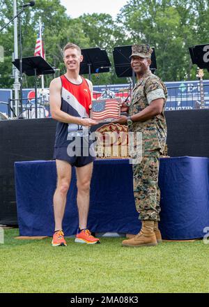 Kyle King, a native of Alexandria, Virginia, wins Marine Corps Marathon Historic Half with a time of one hour, 13 minutes and 24 seconds at the Fredericksburg Expo and Conference Center, Fredericksburg, Virginia, May 22, 2022. The Historic Half is a 13.1 mile race drew roughly 4,000 participants to promote physical fitness, generate goodwill in the community, and showcase the organizational skills of the Marine Corps. The event also included the Semper Five, 5 miles, and the Devil Dog Double, 18.1 miles. Stock Photo