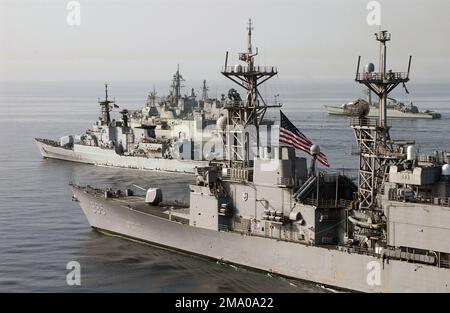 040506-N-7586B-085. [Complete] Scene Caption: Ships from the Multinational Combined Task Force One Five Zero (CTF-150) sail in formation for a photo opportunity while underway in the Gulf of Oman, in support of Operation IRAQI FREEDOM. Pictured foreground-to-background: US Navy (USN) Spruance Class: Destroyer, USS CUSHING (DD 985); the Italian Navy Maestrale Class, Frigate, ITS SCIROCCO (F 573); the New Zealand Navy, Anzac (Meko 200) Class Frigate, HMNZS TE MANA (F 111); the Japanese Maritime Self Defense Force (JMSDF), Murasame Class Destroyer, SAMIDIRE (D-106); the German Navy, Bremen Class Stock Photo