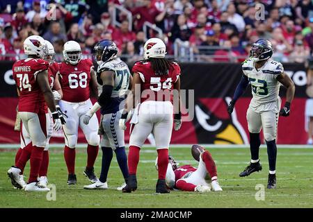 Seattle Seahawks linebacker Boye Mafe, center, works with Aaron Curry,  right, assistant defensive line and defensive ends coach, as linebackers  Tyreke Smith, left, and Joshua Onujiogu, second from left, during NFL  football