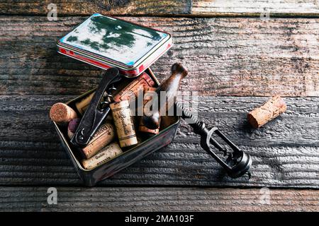 old metal can with cork and corkscrew on a rustic wooden background Stock Photo