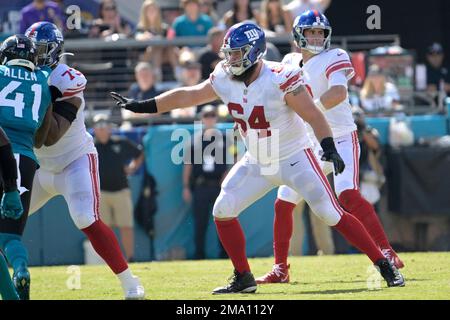 New York Giants guard Mark Glowinski (64) walks off the field after an NFL  football game against the Carolina Panthers, Sunday, Sept. 18, 2022, in  East Rutherford, N.J. (AP Photo/Adam Hunger Stock