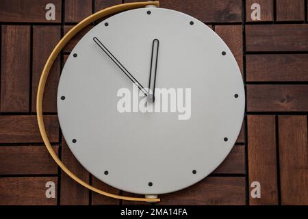 Wall clock at wooden background texture. Flat lay top view composition. Time management concept. Stock Photo