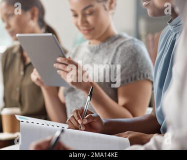 Ready to take down notes. an unrecognizable businessperson writing in a notebook at work. Stock Photo