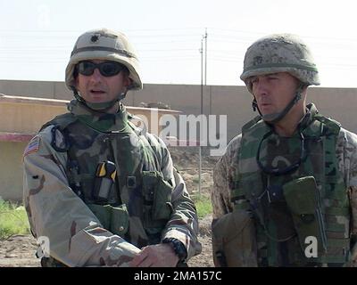 040607-M-0631S-015. [Complete] Scene Caption: US Army (USA) Lieutenant Colonel (LTC) Richard M. Cabrey (left), Battalion Commander, Field Artillery, 1ST Battalion, 5th Field Artillery (1-5), and US Marine Corps (USMC) Colonel (COL) Jerry L. Durrant, Commander, Iraqi Security Forces, 1ST Marine Division (MAR DIV), observe a training event at Camp Ali, the 60th Iraqi Civil Defense Corps (ICDC) training camp during Operation IRAQI FREEDOM and Operation GAUNTLET. The 1ST Brigade Combat Team (BCT), 1ST Infantry Division (ID), is conducting a Joint Training Exercise for the Ar Ramadi Iraqi Police Se Stock Photo