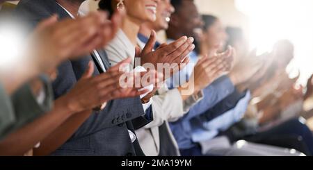 A round of applause. an unrecognizable diverse group of businesspeople applauding while sitting in the boardroom during a presentation. Stock Photo