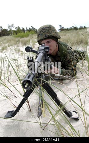 040609-N-1823S-192. [Complete] Scene Caption: US Marine Corps (USMC) Lance Corporal (LCPL) Compton, assigned to B Company, 1ST Battalion, 24th Marine Division takes sight zero on the M240G machine gun, during training conducted at Ustka, Poland, during Exercise BALTIC OPERATIONS 2004 (BALTOPS 04). BALTOPS 2004 is an individual combined maritime and land exercise in the Baltic Sea, conducted 'in the spirit of' Partnership For Peace (PFP). The operation runs from 07-19 June 2004 and includes NATO and non-NATO participants. The mission of BALTOPS 2004 is to promote mutual understanding, confidenc Stock Photo