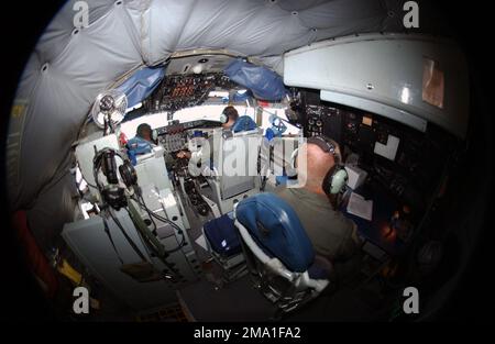 040611-F-3488S-006. [Complete] Scene Caption: Illinois Air National Guard (ILANG) Major (MAJ) Ralph DeLatour (left), Aircraft Commander, and ILANG Captain (CPT) Nick Babiak, co-Pilot, and ILANG SENIOR MASTER Sergeant (SMSGT) Matt Glover, Boom Operator, navigate their ILANG KC-135E Stratotanker on a refueling mission over Alaska (AK) during Exercise NORTHERN EDGE 04. The crew and aircraft are from the 108th Air Refueling Squadron (ARS), 126th Air Refueling Wing (ARW), Scott AFB, Illinois (IL). The Stratotanker's principal mission is air refueling providing support to US Air Force (USAF), US Nav Stock Photo