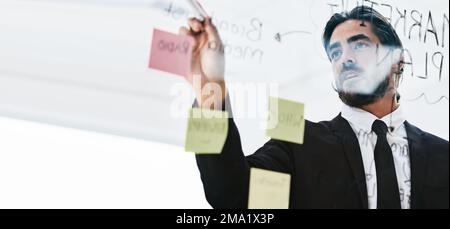 Planning, brainstorming and businessman writing a schedule, idea and strategy on sticky note at work. Innovation, agenda and corporate employee with a Stock Photo