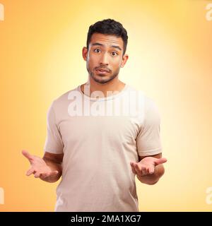 Man, confused and hands out isolated with questions and asking why on yellow background with mockup. Confusion, doubt and person from India with Stock Photo