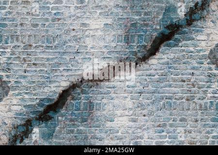 Weathered damaged brick structural plaster wall with dirt Stock Photo