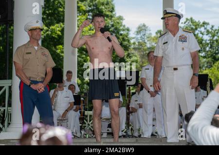 ANNAPOLIS, Md. (May 22, 2021) Vice Admiral Sean Buck, 63rd Superintendent of the U. S. Naval Academy, and Col. James McDonough, Commandant, congratulates Midshipman 4th Class Nick McGowan, 20, of Sioux City, Iowa, after placing the midshipman cover atop the Herndon Monument. USNA freshmen, or plebes, climb the Herndon Monument, a tradition symbolizing the successful completion of the midshipmen's freshman year. The class of 2025 completed the climb in 3 hours, 36 minutes and 58 seconds, the third-longest recorded time. As the undergraduate college of our country's naval service, the Naval Acad Stock Photo