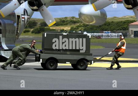 040727-F-1789V-002. [Complete] Scene Caption: US Air Force (USAF) Technical Sergeant (TSGT) Mario de Souza (right), 65th Operational Support Squadron, and two LC-130H crew members (right) move an aircraft power unit (APU) away from The Pride of Scotia, a New York Air National Guard (NYANG) 139th Airlift Squadron (AS), 109th Airlift Wing (AW) LC-130H Hercules cargo aircraft with retractable ski-wheels, as it prepares to take off from Lajes Field, Azores (AZR), Portugal (PRT), on its way back to Stratton Air National Guard Base (ANGB)/Schenectady County Airport in Scotia, New York (NY), after pa Stock Photo