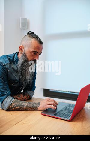 Man using a laptop while working in the office. Stock Photo