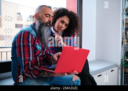 Business colleagues using laptop while working in the coworking office. Stock Photo