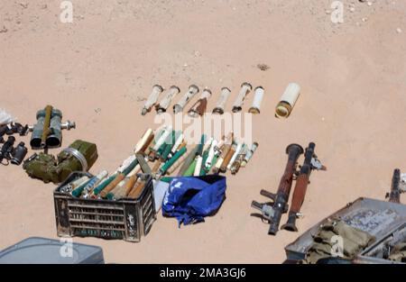 040921-M-2306K-043. [Complete] Scene Caption: Various types of binoculars (left), rocket-propelled grenade (RPG) rounds, and RPG-7 grenade launchers, found by Iraqi Security Forces during a raid of a Muqtada al Sadr safe house in An Najaf, An Najaf Province, Iraq, are displayed by U.S. Marine Corps Marines, 11th Marine Expeditionary Unit (MEU) Special Operations Capable, Sept. 21, 2004. These caches were found in different buildings among the city and are in direct violation of the peace agreement between the Grand Ayatollah Sayyid Ali Husaini al-Sistani, highest religious authority and leader Stock Photo
