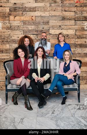 Diverse group of businesspeople looking at camera while posing together in their office. Stock Photo