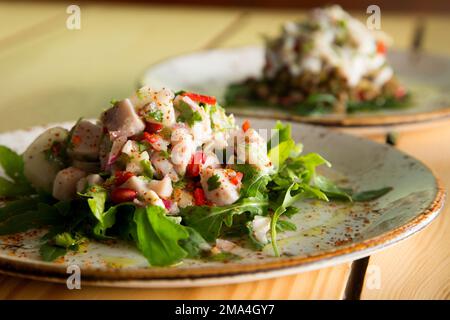 Calamari ceviche. The cebiche or ceviche is a dish consisting of fish marinated in citrus seasonings. Stock Photo