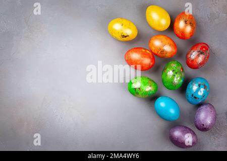 Easter concept wit colorful Easter eggs on grey background. Top view with copy space. Stock Photo