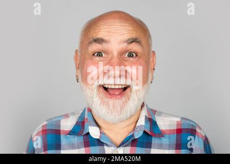 Grandfather pensioner, retiree concept. Happy old mature man smiling. Closeup emotional portrait of an old mature senior man with grey beard isolated Stock Photo