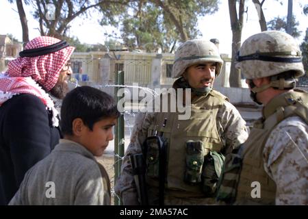 041227-M-2353F-018. [Complete] Scene Caption: U.S. Marine Corps LT. COL. Michael R. Ramos (right) and 1ST LT. Fakhoury (second from right), both with Charlie Company, 1ST Battalion, 3rd Marine Regiment, 1ST Marine Division, talk with Iraqi civilians collecting supplies and humanitarian assistance from U.S. Marine Corps Bravo Company, Combat Service Support Group 15, 2nd Transportation Service Battalion, Marines at Jolan Park in the city of Fallujah, Al Anbar Province, Iraq, on Dec. 27, 2004, during Operation Al Fajr. Operation Al Fajr is part of the ongoing Security and Stabilization Operation Stock Photo