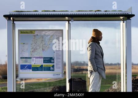 SCHERMERHORN - A man is waiting for the bus that never came. Thousands of bus drivers, drivers and conductors in regional transport will stop working on Thursday and Friday. ANP OLAF KRAAK netherlands out - belgium out Stock Photo