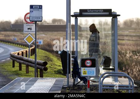 SCHERMERHORN - A man is waiting for the bus that never came. Thousands of bus drivers, drivers and conductors in regional transport will stop working on Thursday and Friday. ANP OLAF KRAAK netherlands out - belgium out Stock Photo