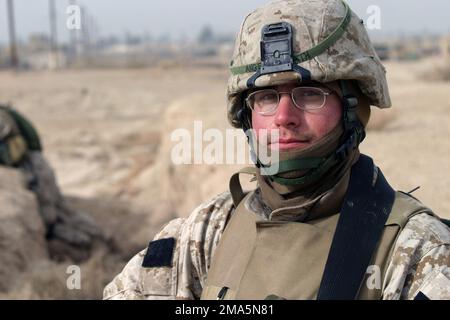 A US Marine Corps (USMC) Marine assigned to Kilo Company, 3rd Battalion, 8th Marines, provides security at a polling site for the upcoming Iraqi elections, in Nasarwasalam, Iraq. The 1ST Marine Division is engaged in Security and Stabilization Operations (SASO), in the Al Anbar Province, Iraq, in support of Operation IRAQI FREEDOM. Subject Operation/Series: IRAQI FREEDOM Base: Nasarwasalam State: Al Anbar Country: Iraq (IRQ) Stock Photo