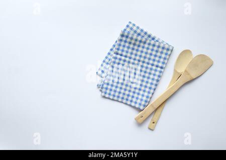 Wooden Spoon and a Blue and White Checked Towel Background. Stock Photo