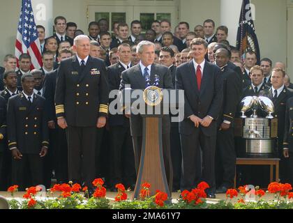 050420-N-0000A-004. [Complete] Scene Caption: US President George W. Bush delivers remarks during the presentation of the Commander-In-CHIEF's Trophy to members of the US Naval Academy (USNA) football team in a ceremony at the White House Rose Garden. President Bush congratulated the team for winning the Commander-In-CHIEF's trophy for the second year in a row. At the podium with President Bush are: US Navy (USN) Vice Admiral (VADM) Rodney P. Rempt (left), US Naval Academy superintendent, and Head Football Coach Paul Johnson (right). The trophy goes each year to the team with the best record i Stock Photo