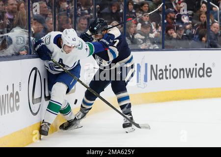 Vancouver Canucks' Quinn Hughes, left, and Jimmy Vesey, right