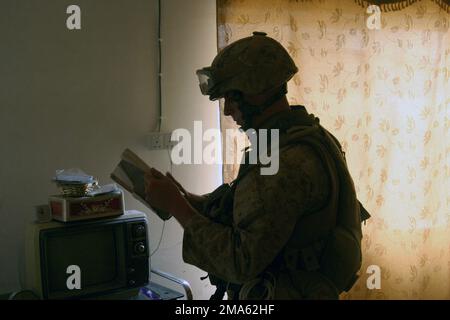 A US Marine Corps (USMC) Marine assigned to 3rd Battalion, 8th Marines (3/8), Lima Company, 4th Platoon, searches through papers found inside a local Iraqi home during Operation Clear Decision. The Marines with 3/8, part of 2nd Marine Division, are conducting Security and Stabilization Operations (SASO) in the Al Anbar Province of Iraq, in support of Operation IRAQI FREEDOM. Subject Operation/Series: IRAQI FREEDOM Base: Al Kharma State: Al Anbar Country: Iraq (IRQ) Stock Photo